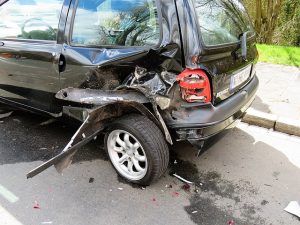 A car that has been hit on the back left tire